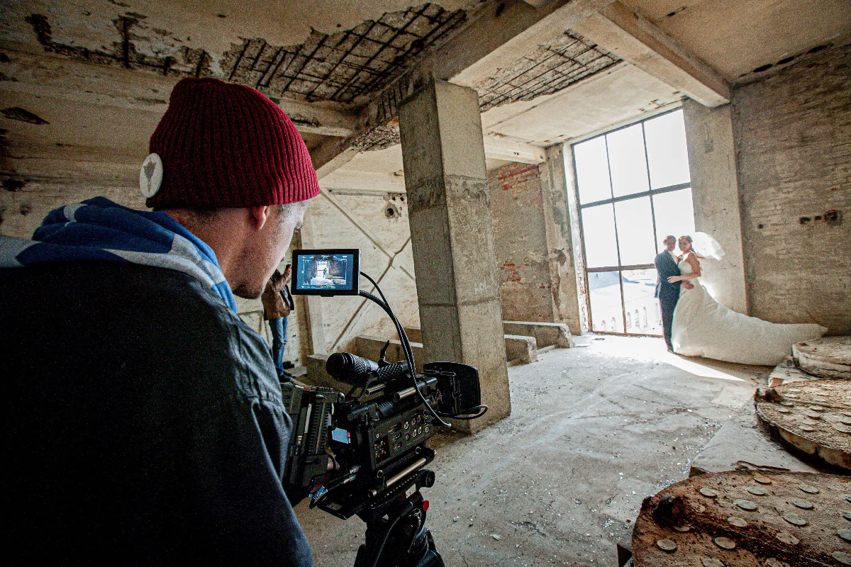 A candid moment during a wedding photoshoot in an abandoned building.