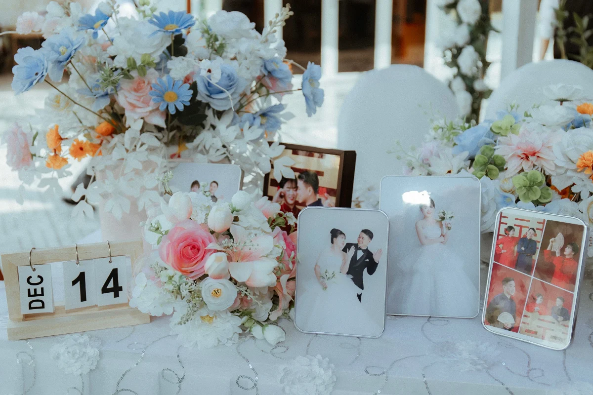 Beautifully decorated wedding table with flowers and framed photos.