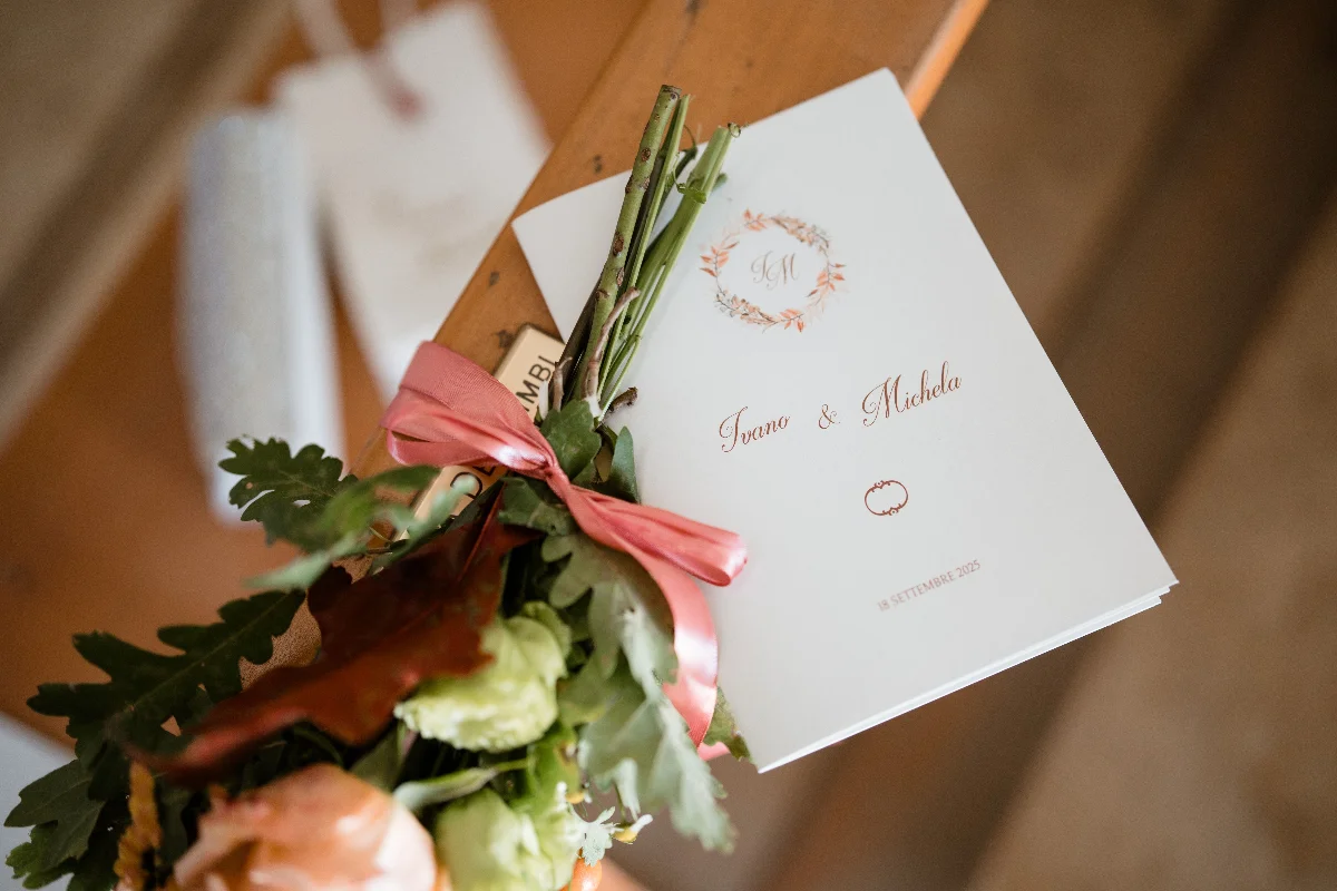 A wedding invitation and bouquet on display, signifying a special day.
