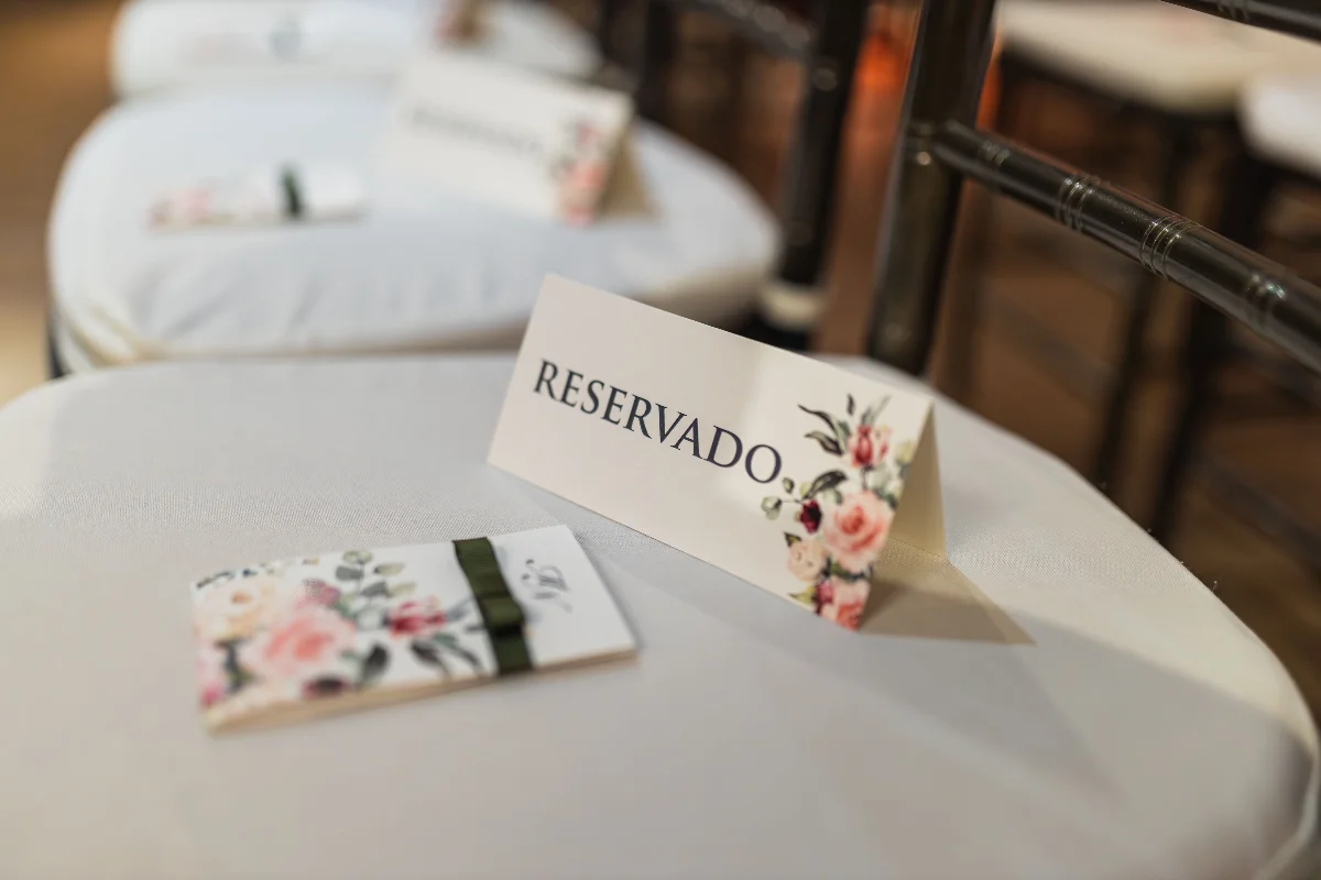 Close-up of a reserved seat at a wedding with floral details, adding elegance and charm.